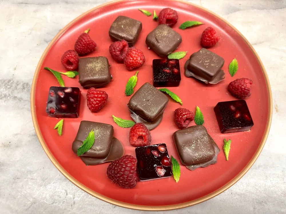 Plate with gelee chocolates, gelees and raspberries