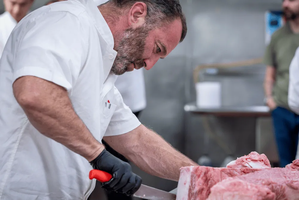 Chef Adam Perry Lang slices Japanese Wagyu at Institute of Culinary Education cooking demonstration.
