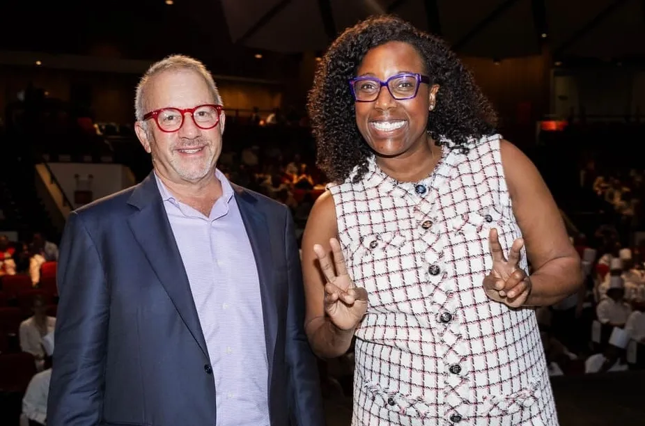 ICE CEO Rick Smilow and alumna Chef Mashama Bailey pose together at a podium during a culinary awards ceremony. Both are smiling and looking at the camera.