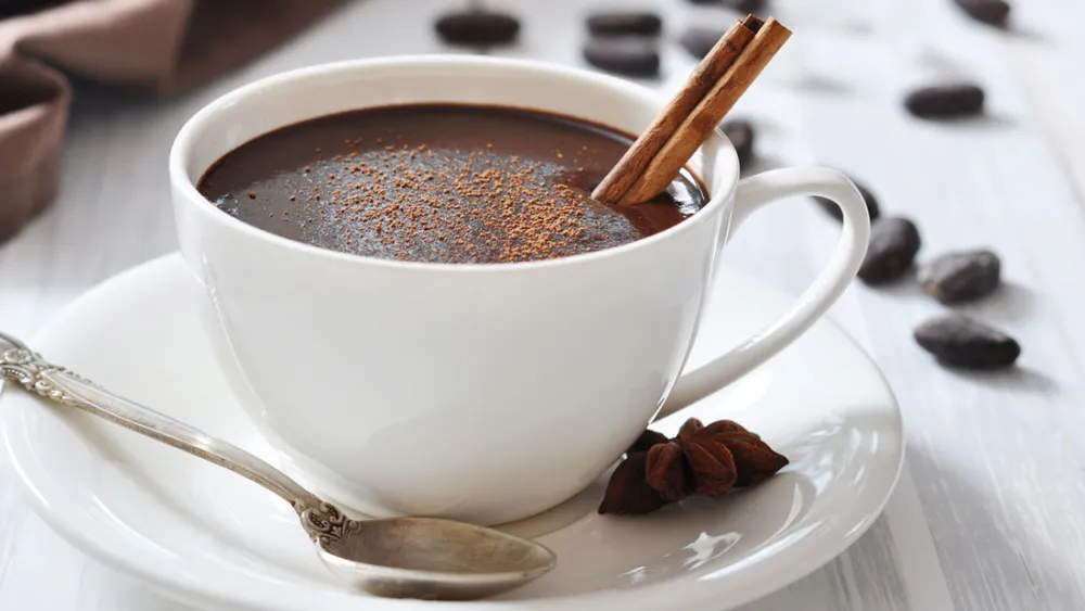 Mug of hot chocolate on a saucer.
