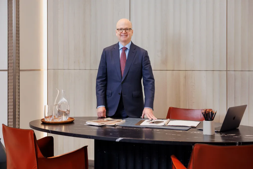 Michael Lawrence stands behind desk