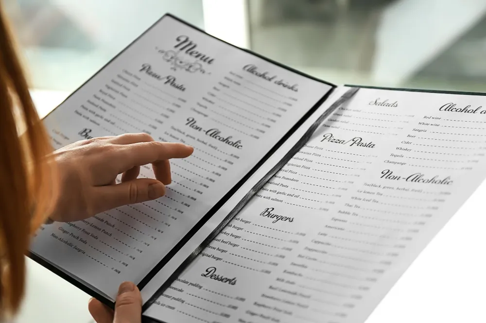 Person reading a menu. Credit: Pixelshot