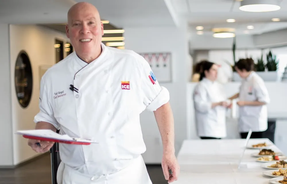 chef ted siegel at ICE with clipboard and chef's coat