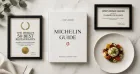 A close-up of the Michelin Guide book, showcasing its iconic red cover and gold Michelin star logo.