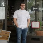 Chef Adriano Piazza smiles while standing in front of Pronto Cucina Italina