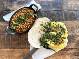 Image of chickpeas al pastor on a wood table top. 