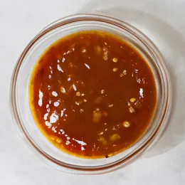 Small bowl of chicken pan sauce.