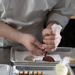 hands piping pastry