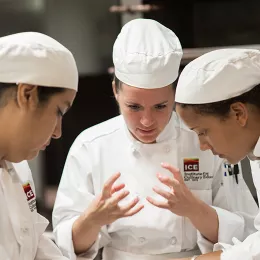 ICE students work together to prepare a dish in culinary school