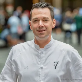 ICE alum Robby Cook faces the camera in his chef whites. photo credit Blue Slip 16D. 