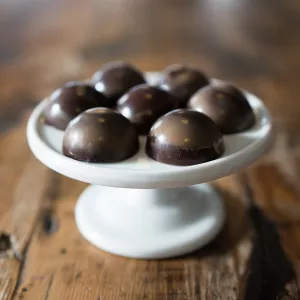Michael Laiskonis’ Balsamic Caramel Bonbons are served on a round platter.