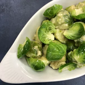 A dish of Brussels sprouts is served.