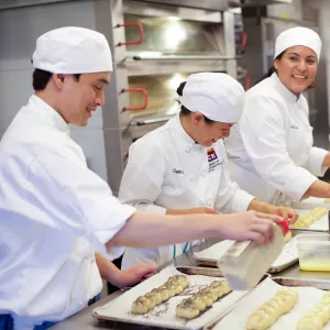 pastry students happily baking bread at school in NYC