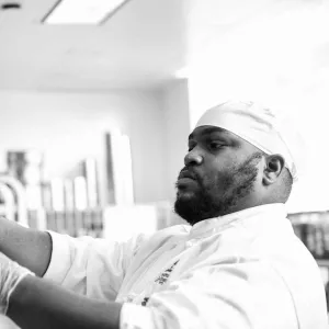 Chef sharpening his knives in a professional kitchen