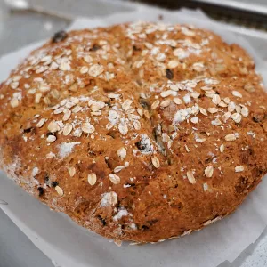 A loaf of Chef Sim Cass' Irish soda bread recipe sits on a piece of parchment paper