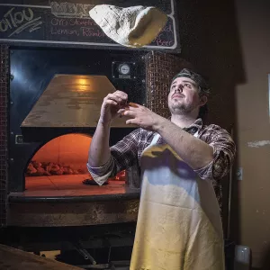 Matt Alter tosses pizza dough at Natalie's in Columbus, Ohio.