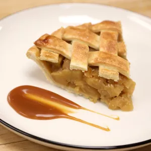 A slice of apple pie on a white plate