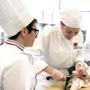 students learning to filet and cook fish
