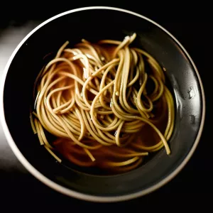 Noodles in a dashi broth in a black bowl