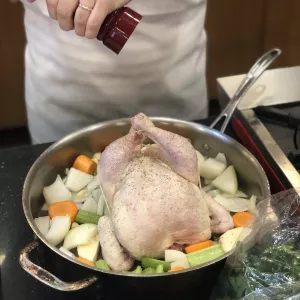 Raw chicken being seasoned