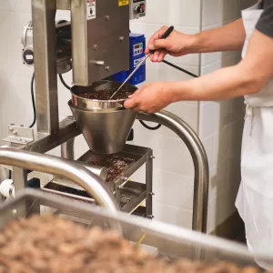 Chef Michael Laiskonis uses equipment in the bean-to-bar chocolate lab