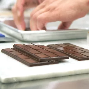 chef removing chocolate bar from mold