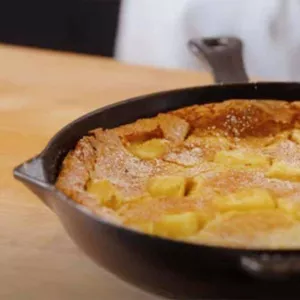 Pineapple clafoutis in a cast iron pan.
