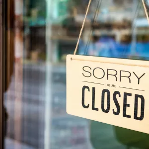 Closed sign hanging in restaurant window