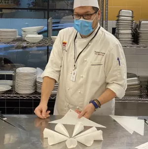Chef Chavez demonstrates making a parchment paper piping bag