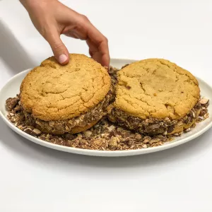 A hand grabs one of Chef Penny's leftover candy cookies.