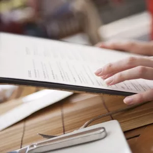 A diner holds a restaurant menu