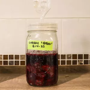 a jar of fermented cherry syrup