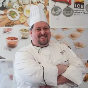 ICE LA Chef-Instructor Patty Zagorski smiles at the camera wearing chef whites.