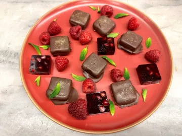 Plate with gelee chocolates, gelees and raspberries