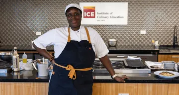 ICE alum Rose Noel poses in the demo kitchen on campus in NYC.