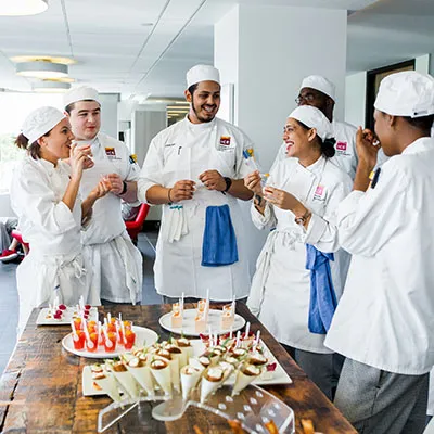 ICE students gathered around hors d'oeuvres
