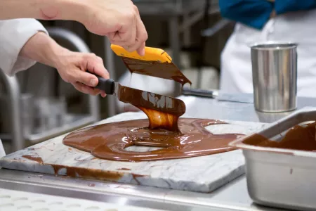 Michael Laiskonis tempering chocolate in the chocolate lab at the Institute of Culinary Education