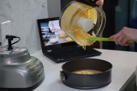 pouring batter while watching online cooking lesson with chef-instructor