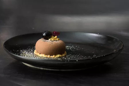 A chocolate dessert with cherry and sesame made by chef Michael Laiskonis at the Institute of Culinary Education