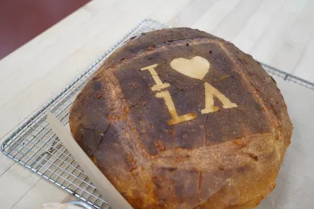A loaf of bread made in the ICE Los Angeles baking arts program with "I love LA" baked into it