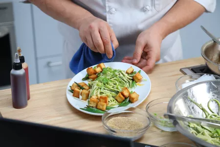 New York plant-based culinary program student presenting zoodles dish