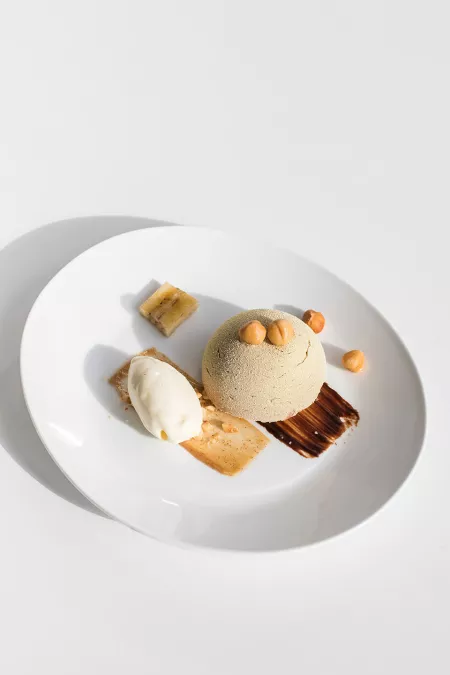 A plated dessert of chocolate and hazelnuts, prepared by ICE pastry program students