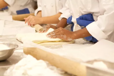 Rolling dough in new york pastry classes