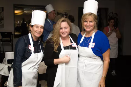 Guidance counselors cooking at an event at the Institute of Culinary Education