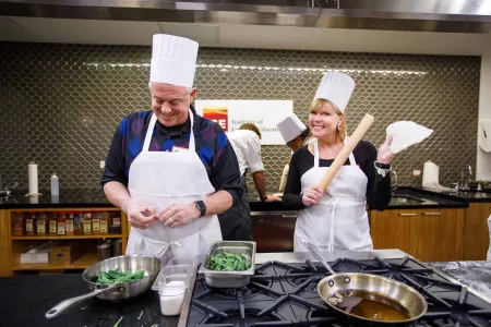 Guidance counselors cooking at an event at the Institute of Culinary Education