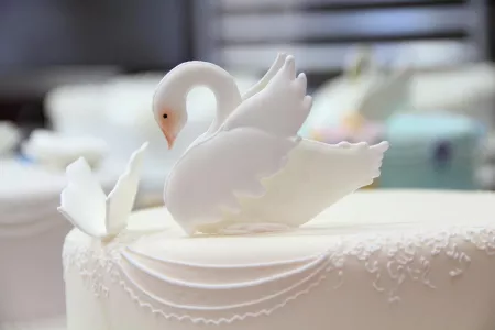 A swan tops a cake decorated in the ICE Professional Cake Decorating continuing education program