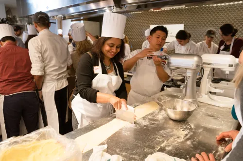 A guest makes pasta at ICE.