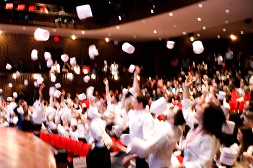 Students celebrate their graduation ceremony from the Institute of Culinary Education