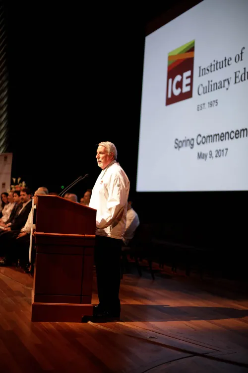 Vice President of Education Richard Simpson addresses students at their graduation ceremony