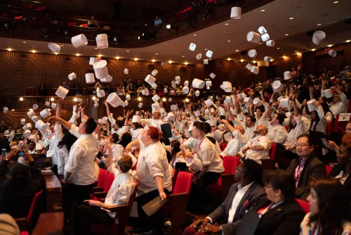 2018-2019 graduates toss their toques.